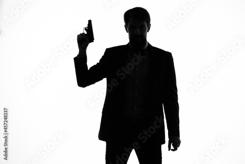 businessmen Secret agent with a gun in the hands of a crime posing studio photo