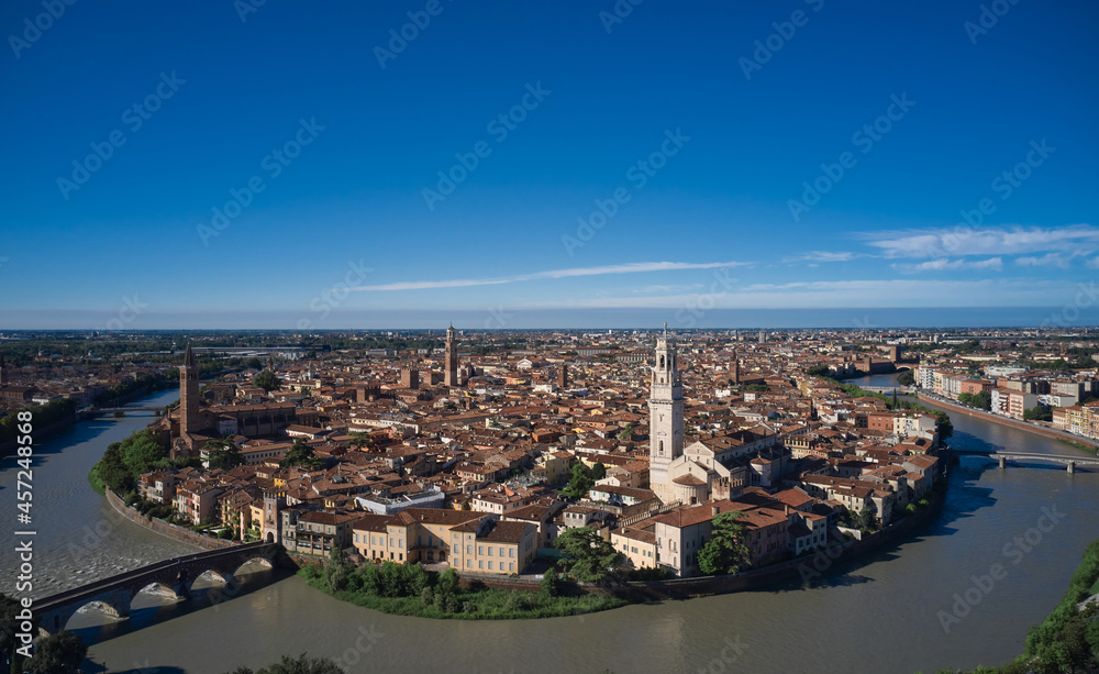 Fototapeta premium Italian medieval city drone view. Aerial panorama of Verona, Italy. Panoramic top view of Verona city center. Italian churches in the old city aerial view. Historic Italian town panorama top view.