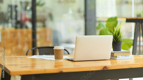 Wallpaper Mural Image of Laptop computer stand on wooden table in coffee shop co-working space Torontodigital.ca