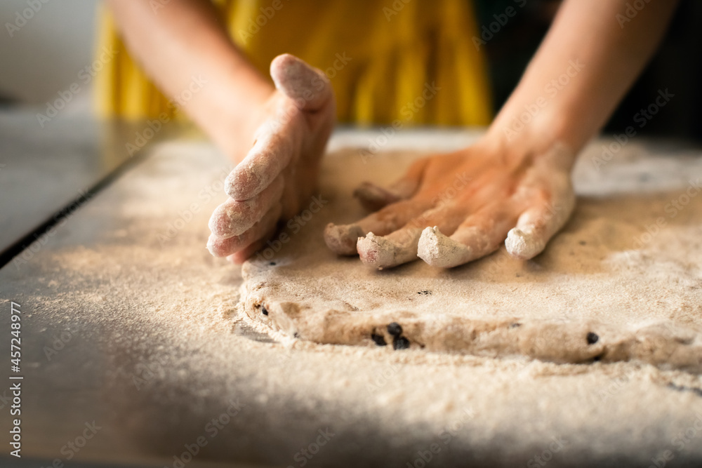 Molding rye sticks with chocolate and hazelnuts by a woman Molding rye sticks with chocolate and hazelnuts by a woman