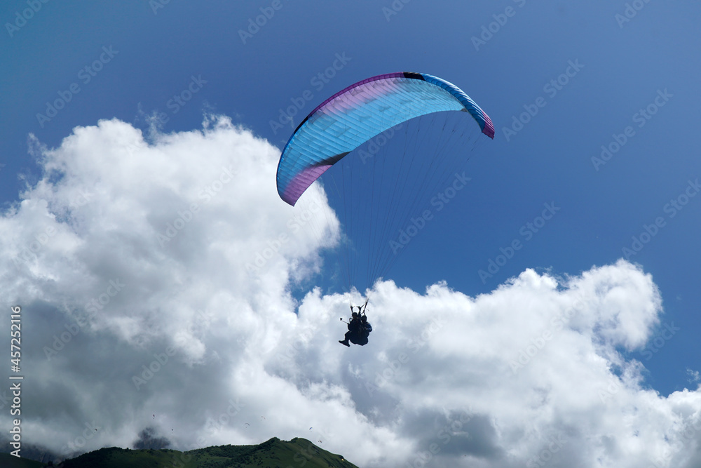 paraglider in the sky in the clouds. instructor. coach. paraglider in the sky in the clouds. instructor. coach.