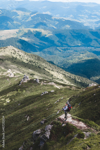 Fototapeta Naklejka Na Ścianę i Meble -  young hiker man in mountains. summer trekking path