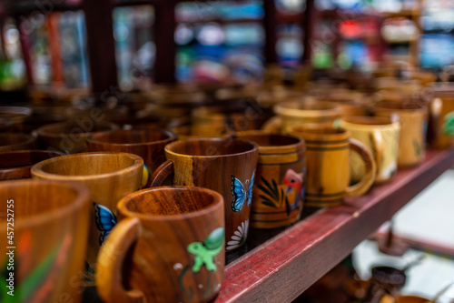 Carved and painted wooden mugs at a market stall