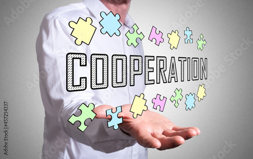Cooperation concept above a human hand