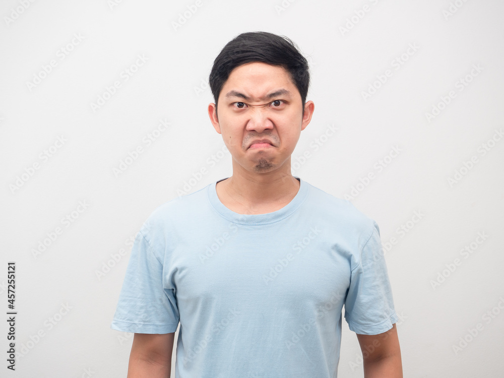 Asian man angry emotion at his face blue shirt white isolated Asian man angry emotion at his face blue shirt white isolated