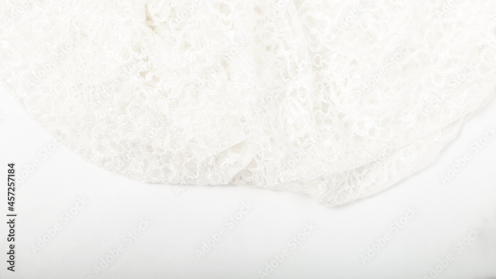 Tailoring. Clothing design. concept of tailoring wedding dresses. White guipure fabric background