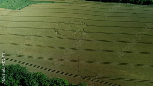 Wiltshire Wootton rivers mysterious crop circle in countryside farmland meadow aerial view tilt up descent photo