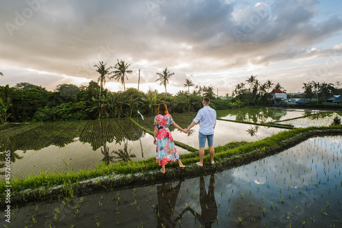 Сouple in love walking in a rice field, Bali, Indonesia.