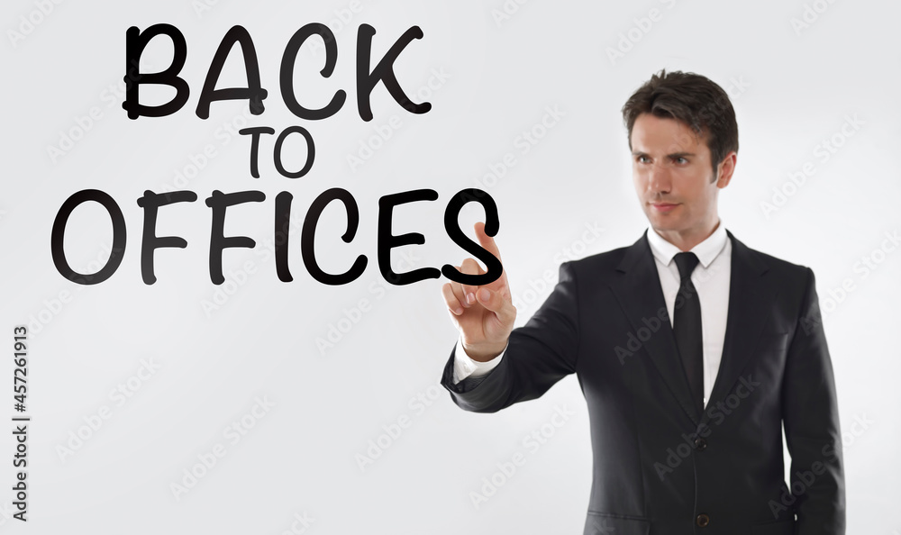 Man touching on a touchscreen with “back to offices” text Man touching on a touchscreen with “back to offices” text