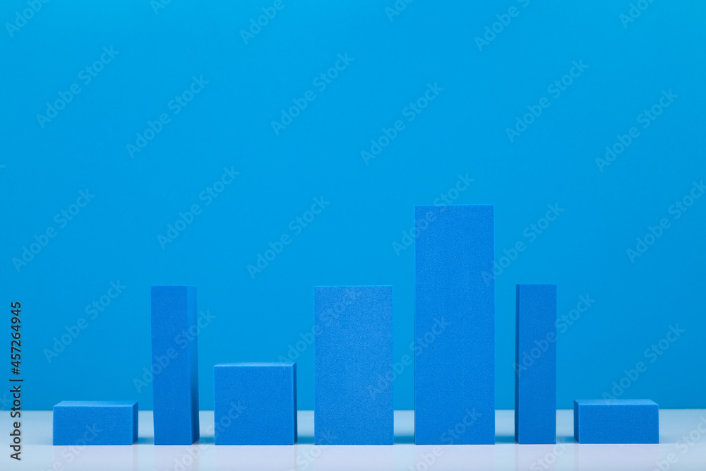 Business concept. Blue performance chart or graph diagram with rise and fall dynamic against blue background. Chart marketing, annual or corporate report, sales or growth evaluation or analytic or pro