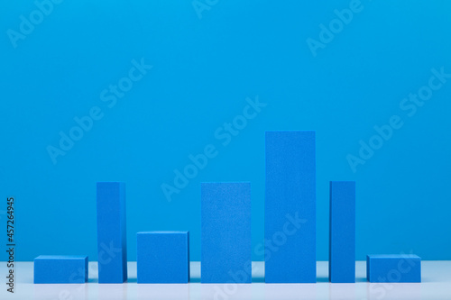 Business concept. Blue performance chart or graph diagram with rise and fall dynamic against blue background. Chart marketing  annual or corporate report  sales or growth evaluation or analytic or pro