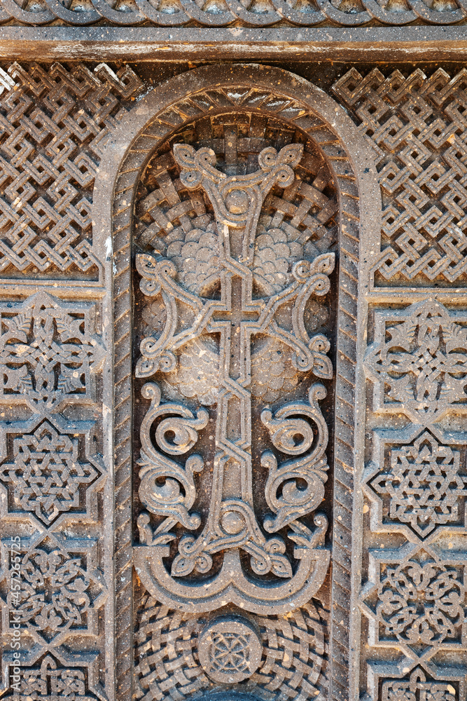 Traditional carved khachkar or cross-stone made of pink tuff installed near Hovhannavank monastery. Armenian heritage and Art
