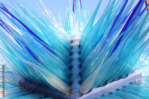 An abstract, blue glass sculpture with a lot of spikes.
