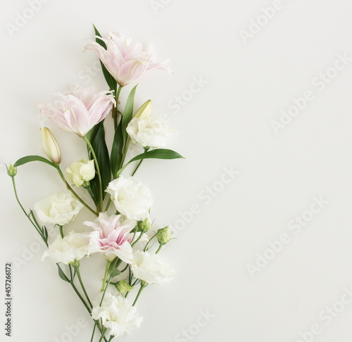 White and pink flowers frame on white background top view, copy space. Flowers composition template.Floral card.