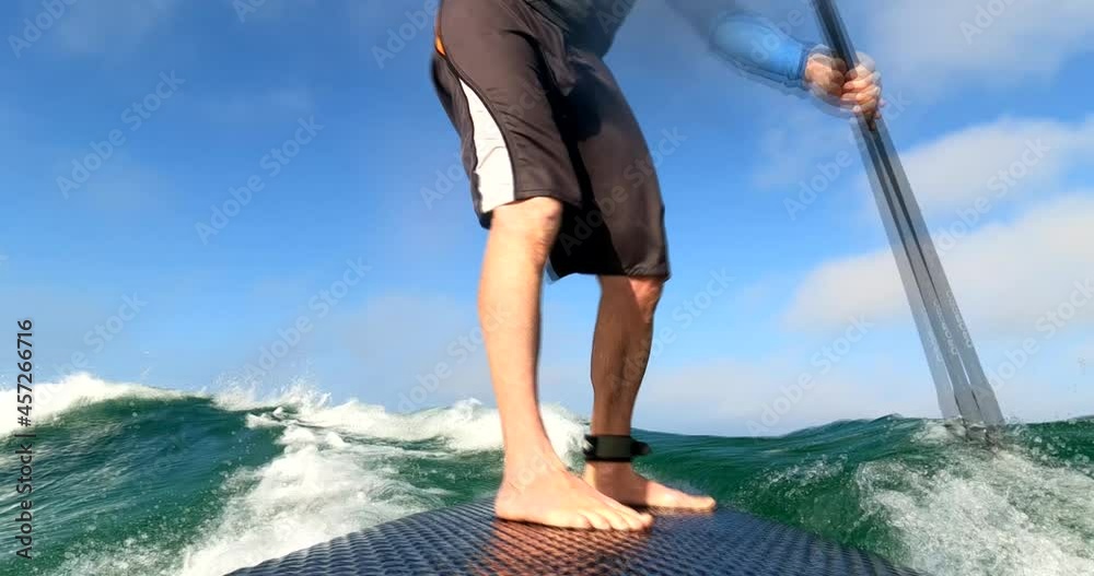 middle aged man paddle boarding