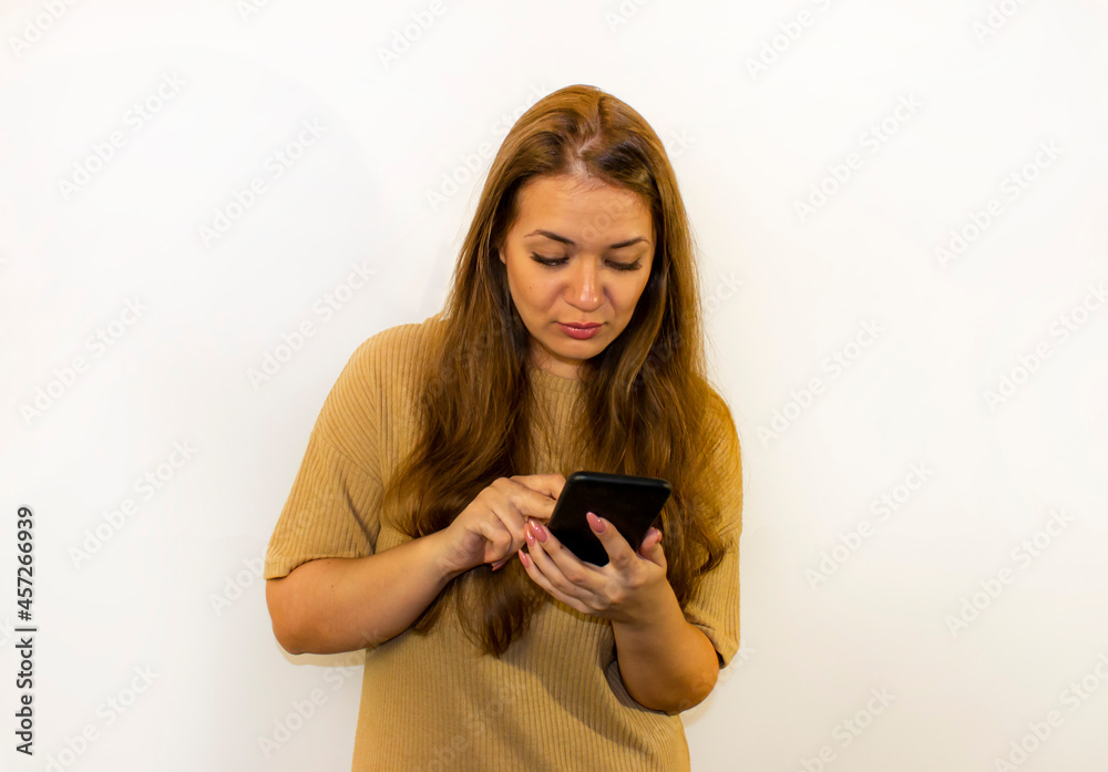 young beautiful woman with a smartphone, writes a message, makes a selfie, communicates young beautiful woman with a smartphone, writes a message, makes a selfie, communicates