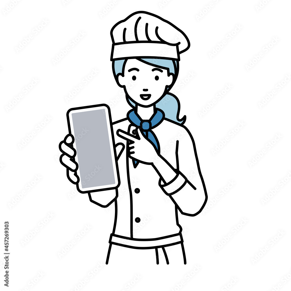 立ってスマートフォンを指差してこちらに向けて見せている調理師の女性 立ってスマートフォンを指差してこちらに向けて見せている調理師の女性