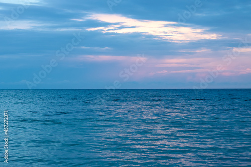 coastline photo  with purplish-blue clouds and sky