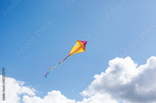 A multicolored kite soars in the sky