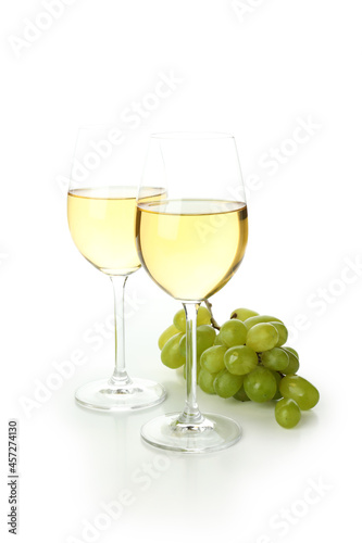 Glasses of wine and grape isolated on white background