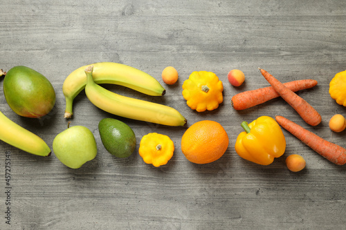 Set of different vegetables and fruits on gray textured background
