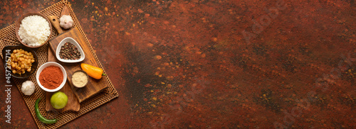 Traditional Indian food and spices on color background with space for text photo