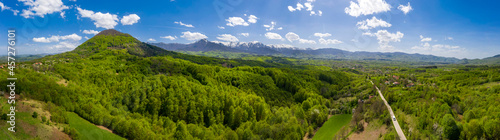 panoramic view from drone of the mountain with green hills and road in spring