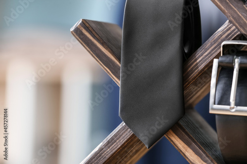 Stand with stylish necktie and belt, closeup