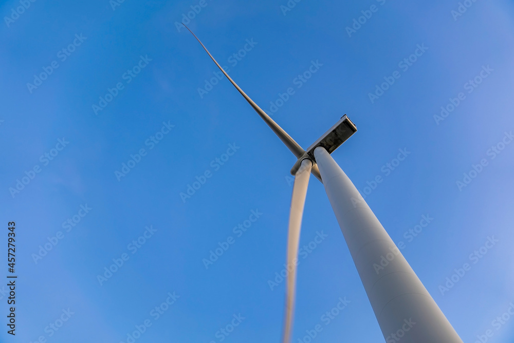 Aerial view of the wind turbines. Green ecological power energy generation. Wind farm eco field. Offshore and onshore windmill farm green energy at sea. Aerial view of the wind turbines. Green ecological power energy generation. Wind farm eco field. Offshore and onshore windmill farm green energy at sea.