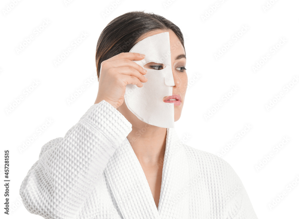 Beautiful young Asian woman with sheet facial mask on white background Beautiful young Asian woman with sheet facial mask on white background