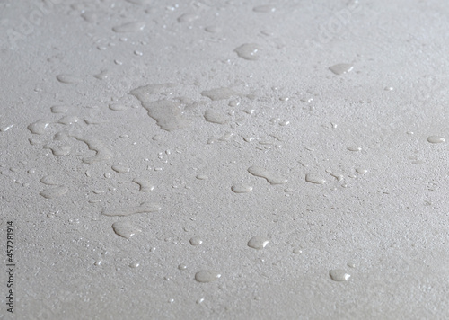 water drops on a concrete floor, microcement wet waterproof cement surface