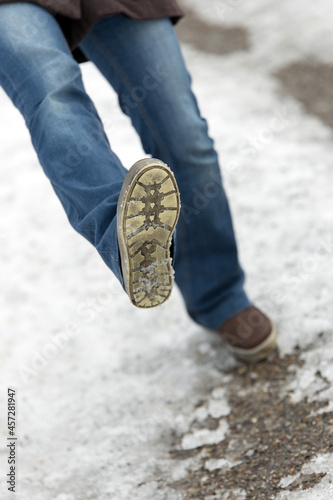 Photography Closeup Woman is slipping and falling on a icy street