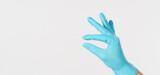 Empty fingers is do holding gesture on white background.Hand wear medical glove.