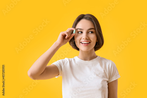 Young woman with ear plug o...