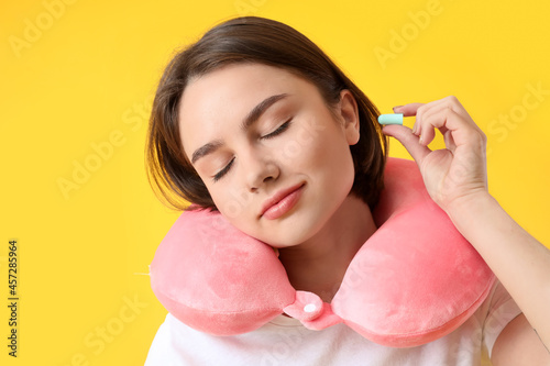 Young woman with neck pillo...