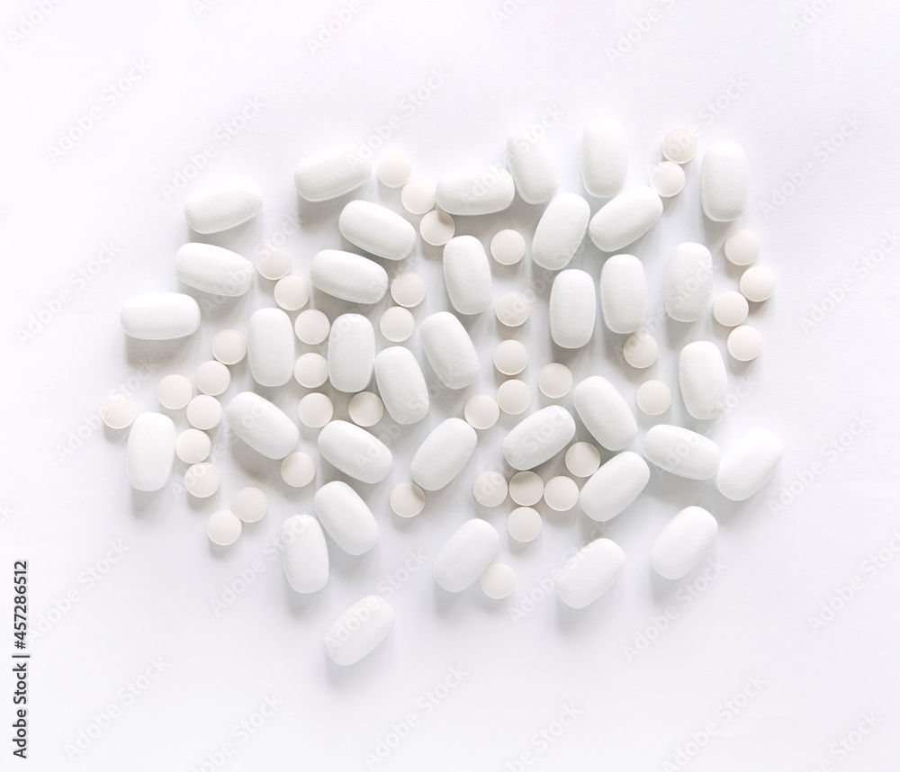 White pills on a White background. Healthcare and medicine.	