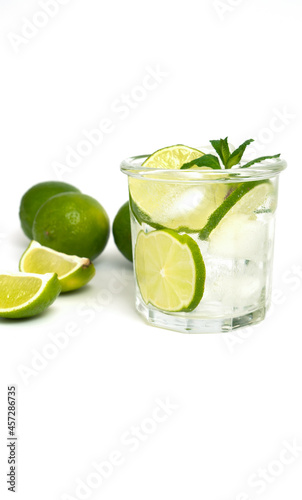 Glass of water with lime, ice and mint. Isolated on white background.