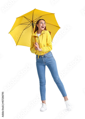 Beautiful young woman with umbrella on grey background