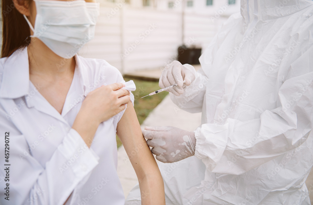 Doctor protective suit taking a nasal swab from a person to test for possible coronavirus infection. Doctor protective suit taking a nasal swab from a person to test for possible coronavirus infection.