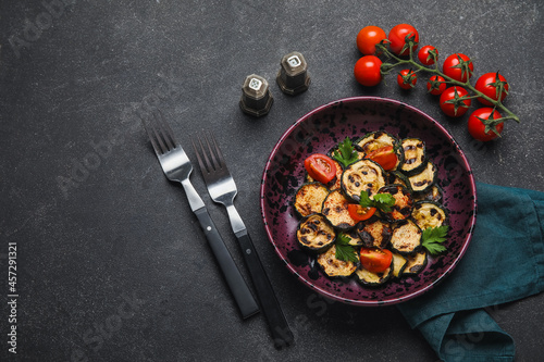 Composition with tasty grilled zucchini on dark background