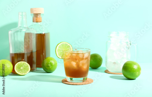 Glass of tasty Long Island iced tea on color background