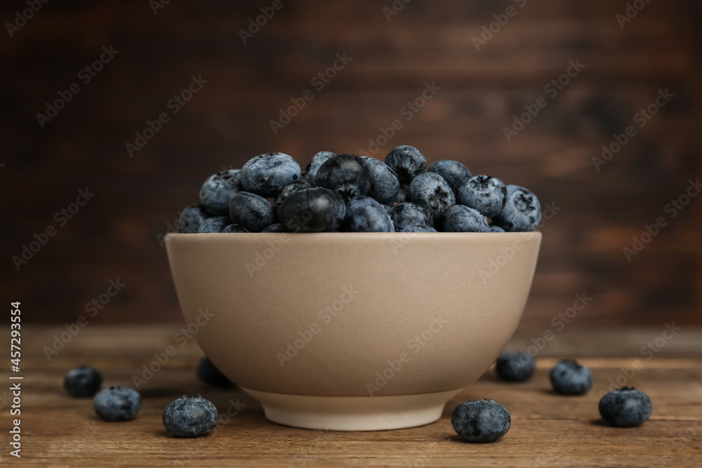 Ceramic bowl with blueberries on wooden table. Cooking utensil Ceramic bowl with blueberries on wooden table. Cooking utensil