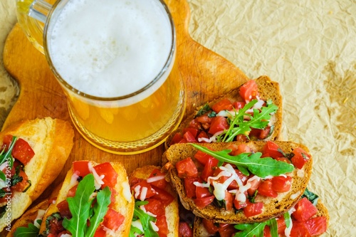 Beer drink bruschetta sausages pizza. fresh vegetable.