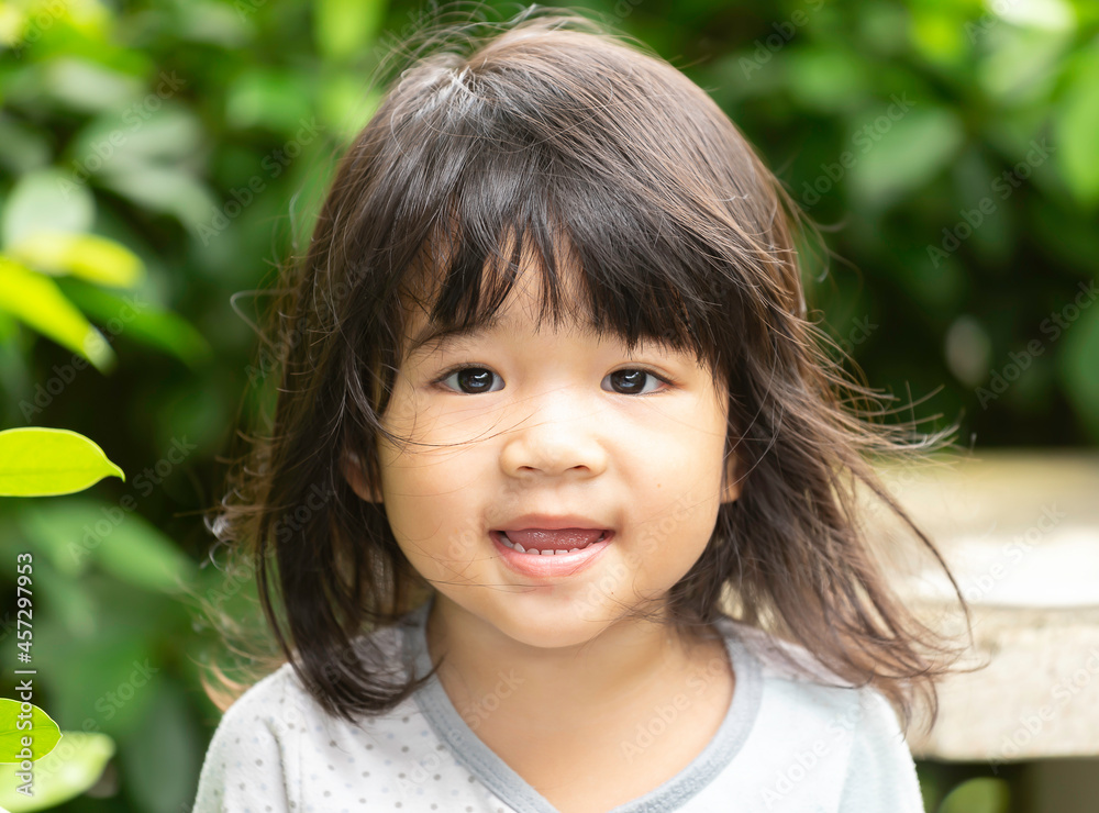A headshot portrait of a cheerful baby Asian woman, a cute toddler little girl with adorable bangs hair, a child wearing a blue sweater smiling and looking to the camera. A headshot portrait of a cheerful baby Asian woman, a cute toddler little girl with adorable bangs hair, a child wearing a blue sweater smiling and looking to the camera.