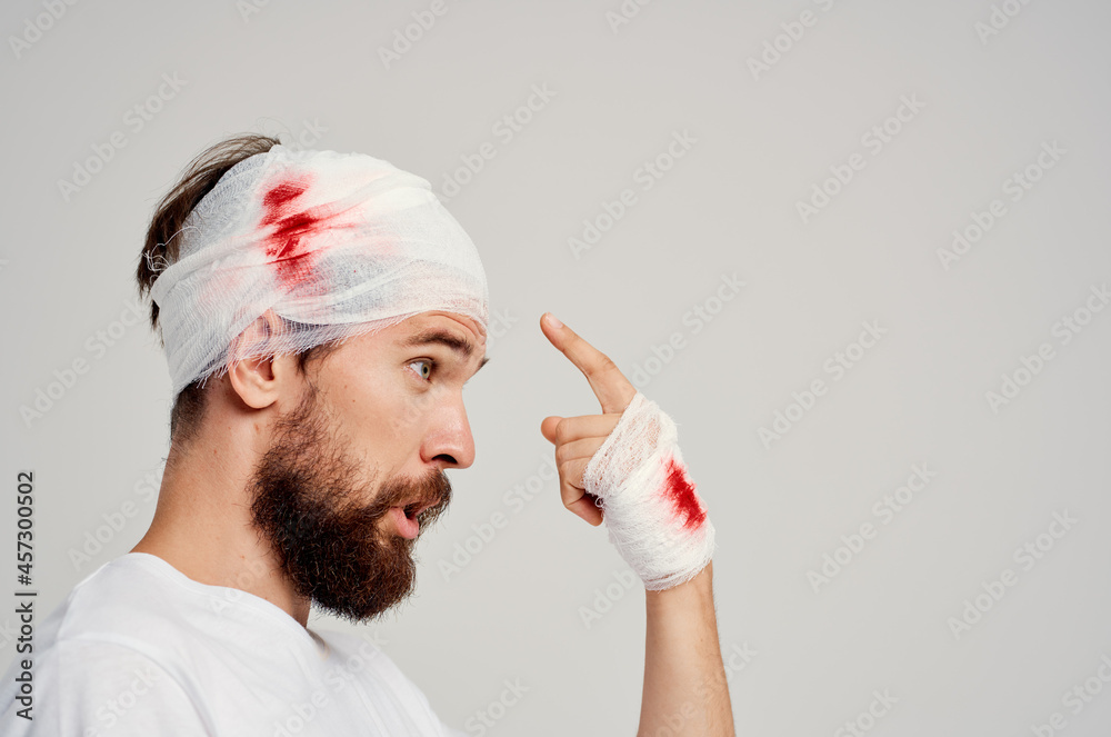 Man bandaged head and hand blood isolated background Man bandaged head and hand blood isolated background
