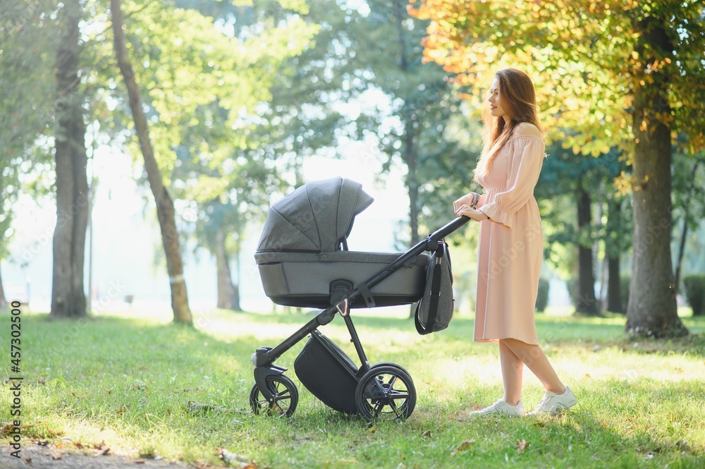 Mother with baby carriage in the park Mother with baby carriage in the park
