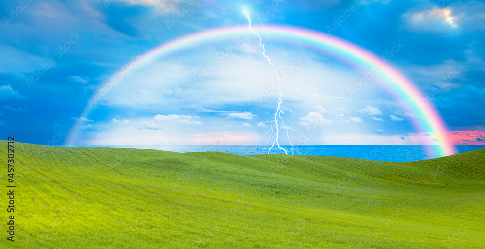 Beautiful landscape with green grass field amazing rainbow in the background Beautiful landscape with green grass field amazing rainbow in the background
