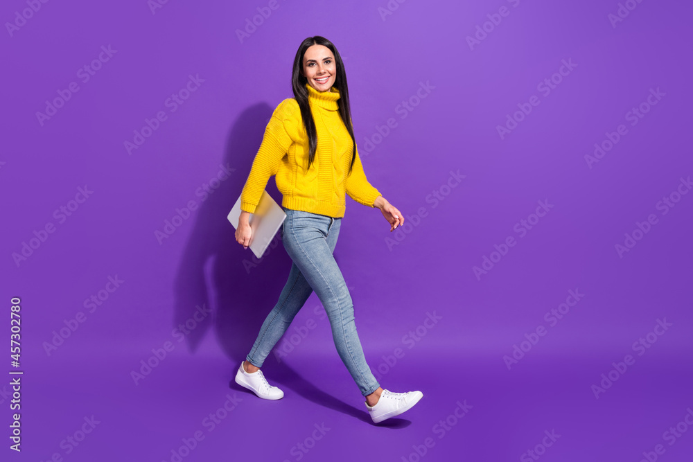 Full size profile photo of charming positive girl walking look camera isolated on violet color background