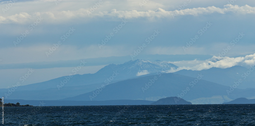 Landscape layers on a cloudy day, with Mount Ruapehu in the distance, looking over Lake Taupo, from Taupo, New Zealand