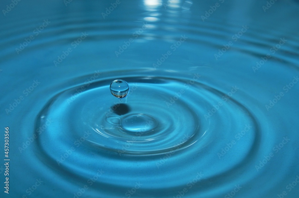water drop splash background blue, water ripple and antibubble drop - water surface tension water drop splash background blue, water ripple and antibubble drop - water surface tension